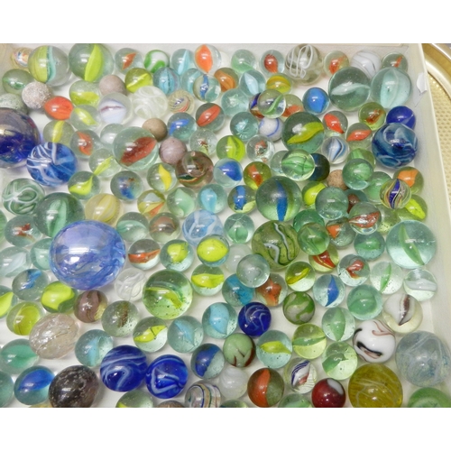 327 - A collection of  glass marbles together with a turned wood solitaire board.