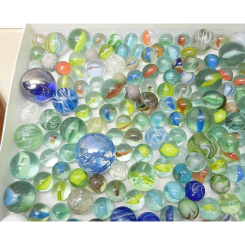 327 - A collection of  glass marbles together with a turned wood solitaire board.