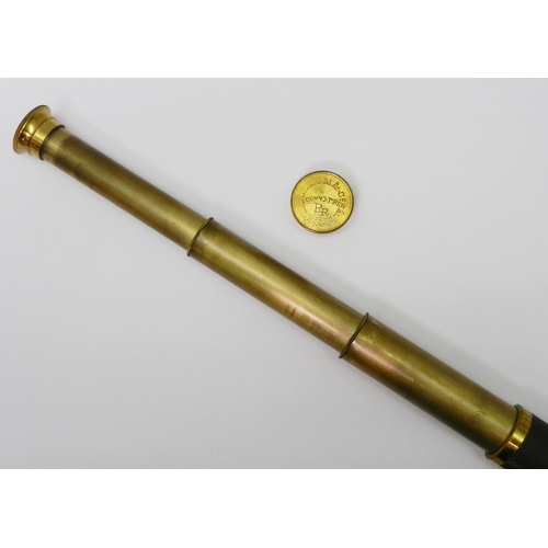 328 - A gilt brass and leather three draw pocket telescope.  150mm closed.