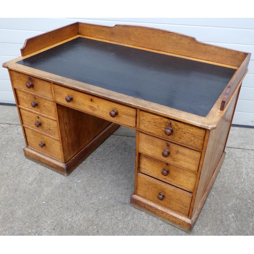 823 - A Victorian oak kneehole desk, one drawer rest pushed in, 137cm wide