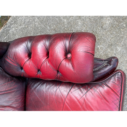 799 - A leather button back three seater sofa and matching arm chair (2)