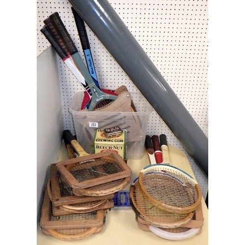 253 - A group of vintage tennis rackets together with advertising tins