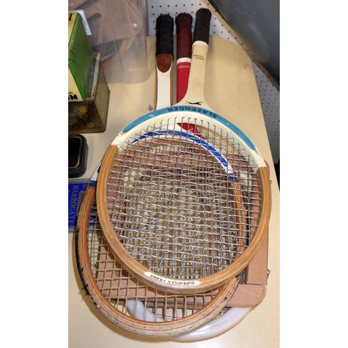 253 - A group of vintage tennis rackets together with advertising tins