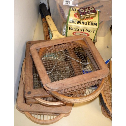 253 - A group of vintage tennis rackets together with advertising tins