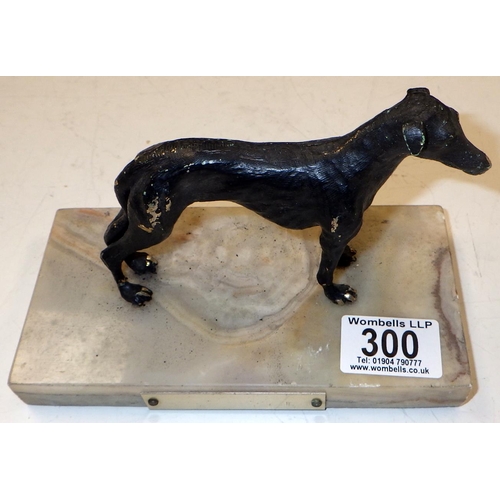 300 - A cast metal figure of a Greyhound on a marble base