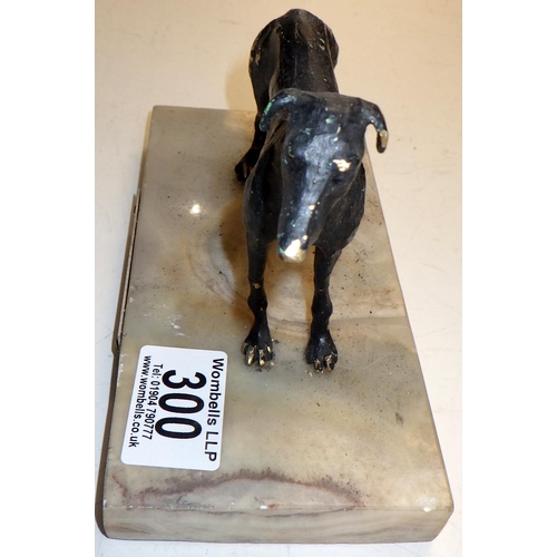 300 - A cast metal figure of a Greyhound on a marble base