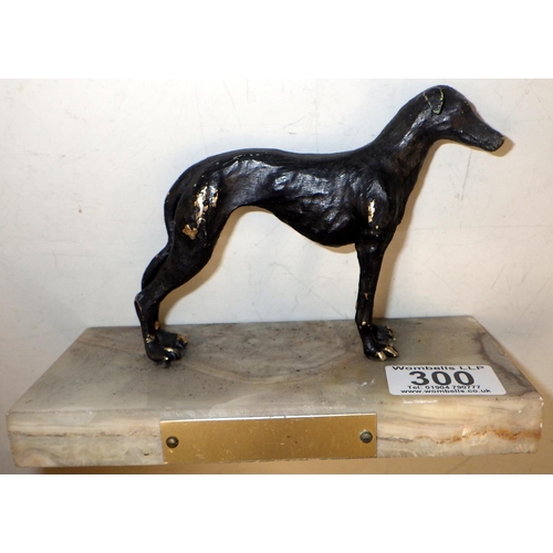 300 - A cast metal figure of a Greyhound on a marble base