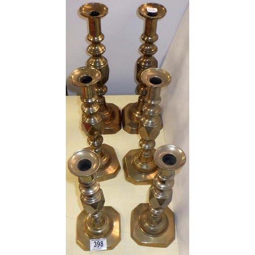 398 - Three pairs of brass candlesticks