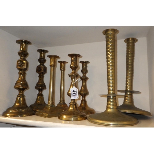 418 - Four pairs of brass candlesticks