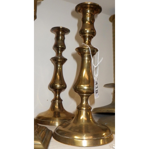 418 - Four pairs of brass candlesticks