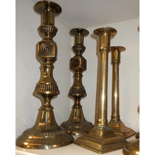 418 - Four pairs of brass candlesticks
