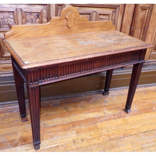 721 - A mahogany side table with fluted frieze and legs, faded top, 125cm wide, ex Bootham Park Hospital