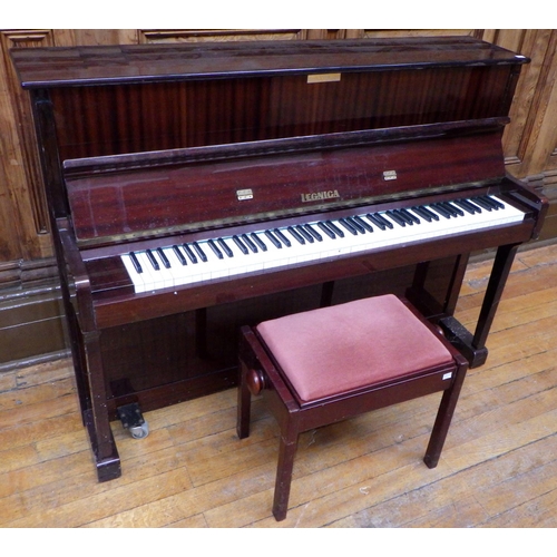 743 - An Legnica upright piano, missing music rest and with later added castors,  with stool, ex Bootham P... 