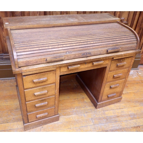 759 - A 1930's oak roll top desk, 127cm wide, ex Bootham Park Hospital