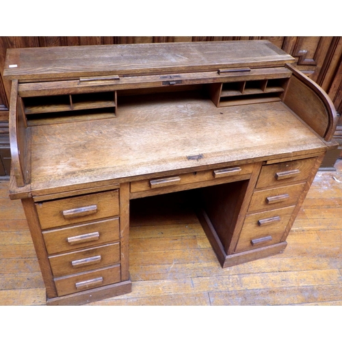 759 - A 1930's oak roll top desk, 127cm wide, ex Bootham Park Hospital