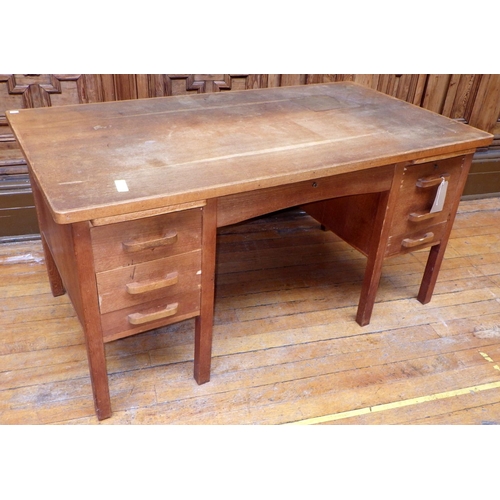 761 - A 1950's oak/ply office desk, veneer damage, 153cm wide, ex Bootham Park Hospital