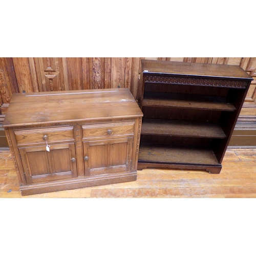 762 - An Ercol two door dresser base, missing rack,  together with an open low bookcase, (2) ex Bootham Pa... 