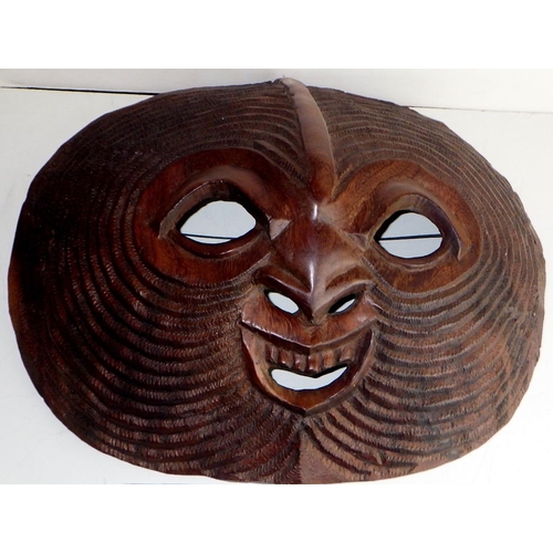 446 - A carved hardwood wall mask, believed African / Ghanaian.  Approx 50 x 42cm