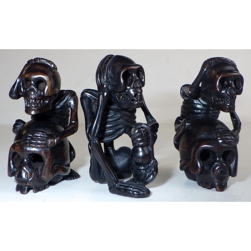 469 - Japanese netsukes: three carved wood skeletons, carved wood all signed.  Approx 5cm tall.