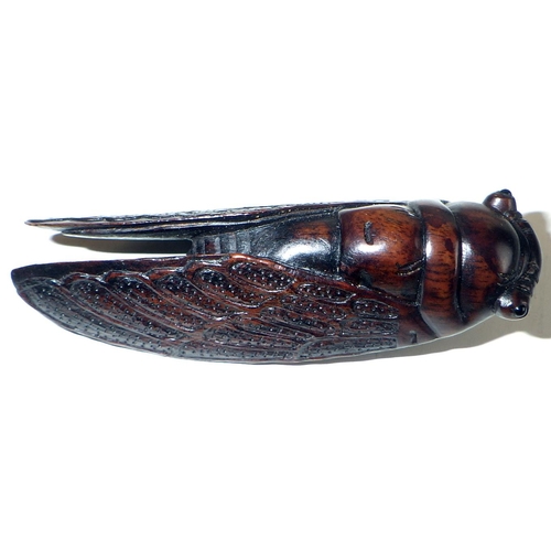 470 - Japanese Netsukes: a carved wood locust, 6.5cm long; a fly eating a piece of fruit, and two others. ... 