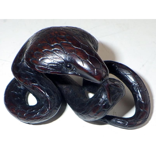 473 - Japanese netsukes: three carved wood examples, all snakes.