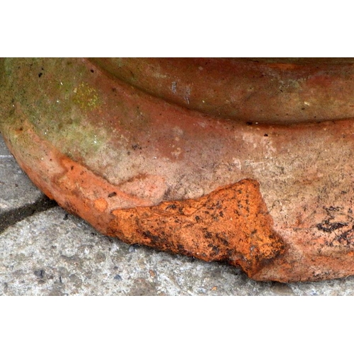 913 - A terracotta garden planter chip to base, 56cm tall