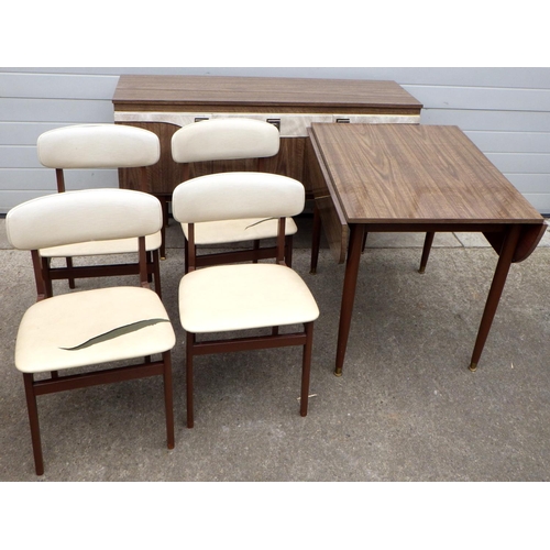 923 - A 1960's, brown formica dining suite incl drop leaf table, sideboard and four chair frames, seats sp... 