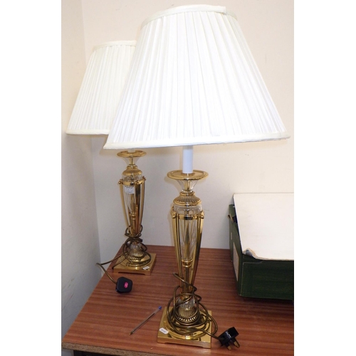 561 - A pair of brass and glass table lamps