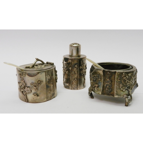 22 - A Chinese three piece condiment set, white metal naturalistically modelled as tree trunks with prunu... 