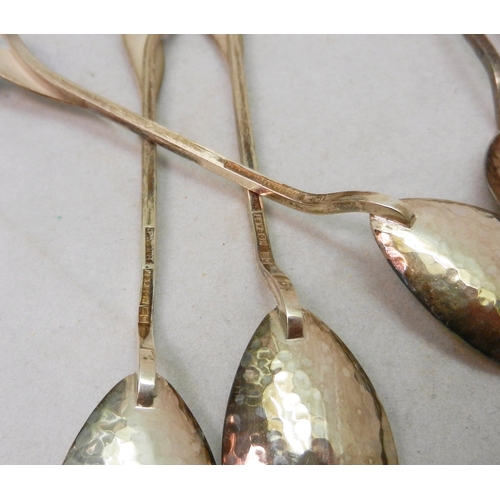 23 - Six matching coffee spoons, Arts and Crafts influence modelled with leaf terminals, white metal mark... 