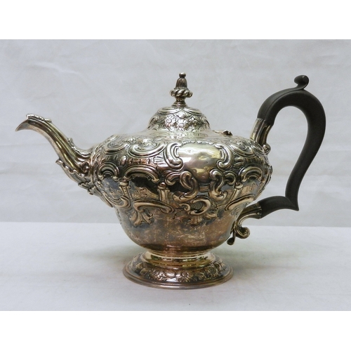 26 - A Victorian silver three piece repousse matched tea set comprising teapot, tripod milk jug, and suga... 