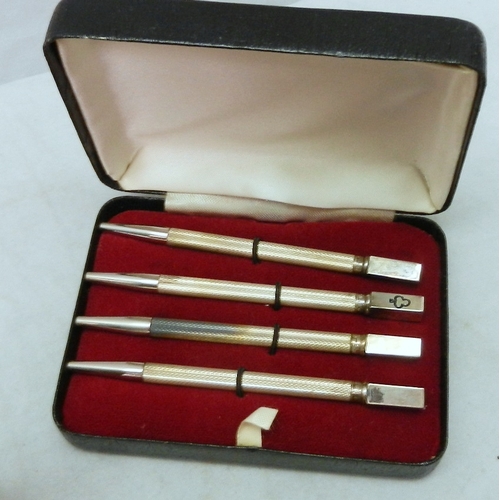 33 - A cased set of four bridge / whist scorer pencils, white metal marked 