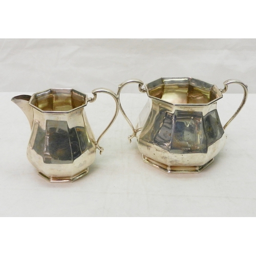5 - An Arts & Crafts three piece silver tea set comprising a teapot, jug and two handled bowl, Goldsmith... 