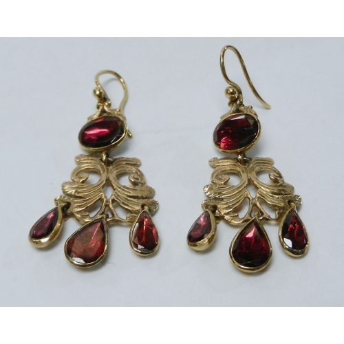 62 - A pair of droplet earrings, 9ct  gold each set with four synthetic rubies.  42mm drop / 5g gross