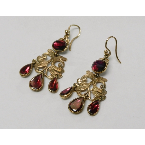 62 - A pair of droplet earrings, 9ct  gold each set with four synthetic rubies.  42mm drop / 5g gross