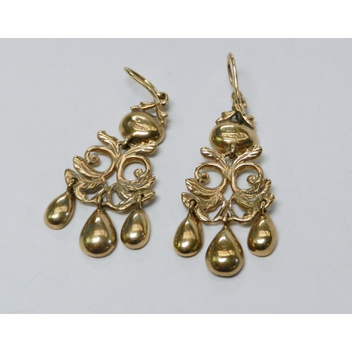 62 - A pair of droplet earrings, 9ct  gold each set with four synthetic rubies.  42mm drop / 5g gross