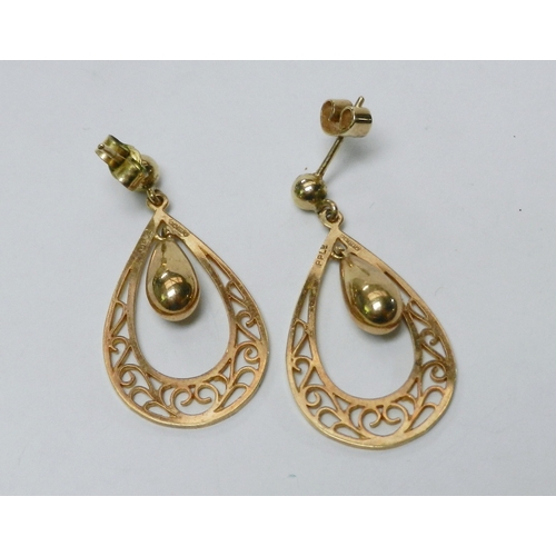 63 - A pair of droplet earrings comprising a suspended pear-drop within a pierced hoop, 9ct gold.  32mm l... 