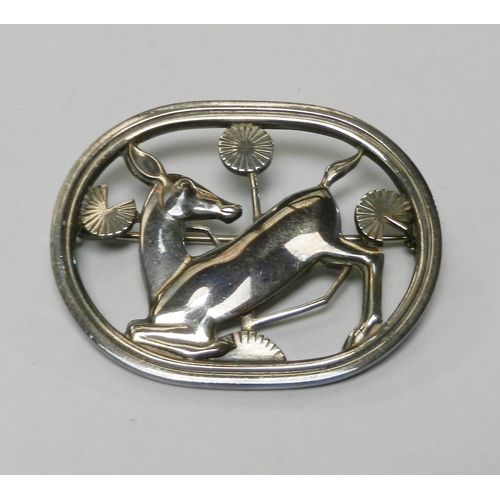 67 - Georg Jensen: a brooch depicting a stylized deer in foliage, design number 256.  Presented in a Geor... 