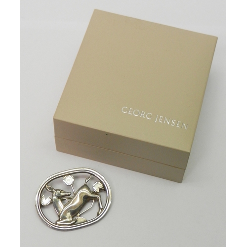 67 - Georg Jensen: a brooch depicting a stylized deer in foliage, design number 256.  Presented in a Geor... 