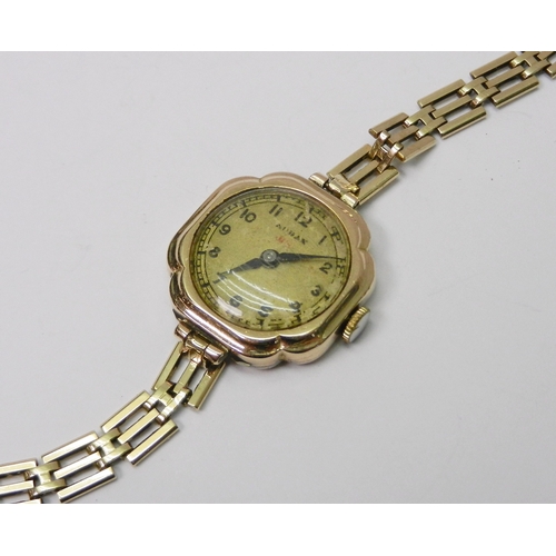 113 - An Audax ladies 9ct gold bracelet watch.  21mm across head / 180mm long incl strap / 14g gross