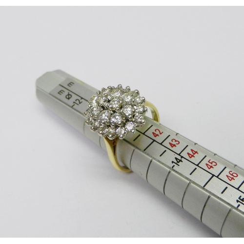 122 - A cluster ring comprising two central round cut diamonds surrounded by a ring of eight similar round... 