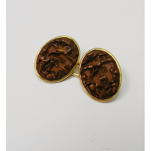 82 - A pair of Chinese chain link cufflinks comprising four similar oval carved nut urban views in unmark... 