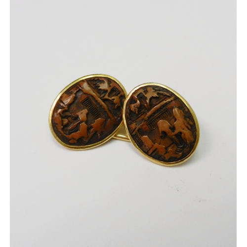 82 - A pair of Chinese chain link cufflinks comprising four similar oval carved nut urban views in unmark... 