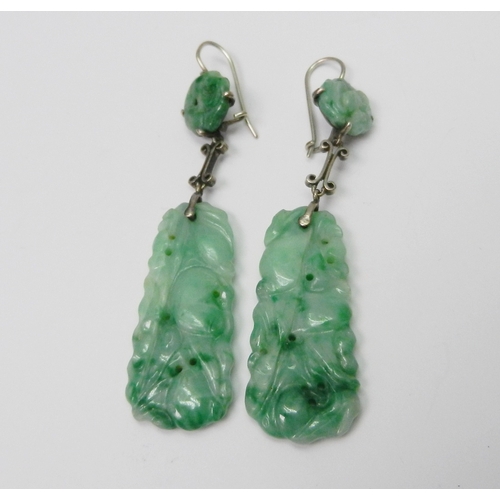 84 - A pair of jade panel earrings each comprising a rectangular and circular carved panels suspended and... 