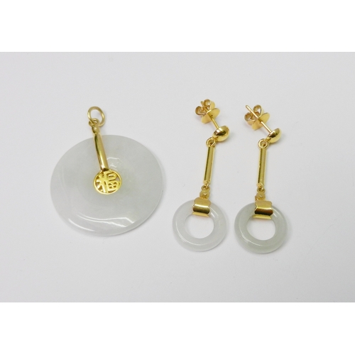 85 - A pair of white jade polished hoop droplet earrings having unmarked yellow metal fittings, each appr... 