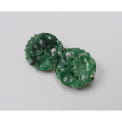 88 - A jade panel brooch on an unmarked white metal mount, the panel carved with a scene depicting an ele... 