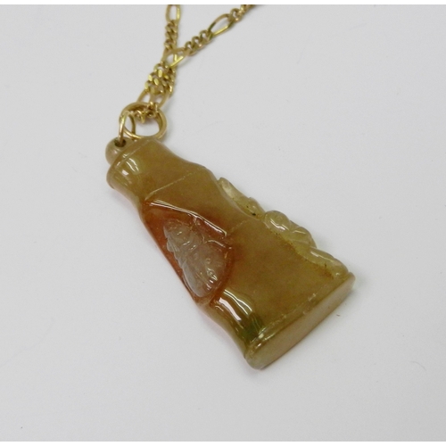 89 - A brown jade pendant carved and depicting a bug inside a branch, 47mm long incl suspension loop, the... 