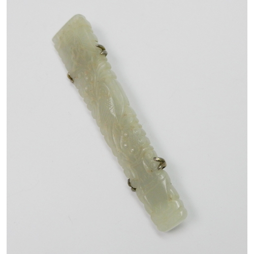 91 - A white jade panel brooch pierced and carved with a vertical design incorporating a vase, bird, flow... 