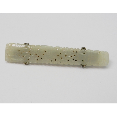 91 - A white jade panel brooch pierced and carved with a vertical design incorporating a vase, bird, flow... 