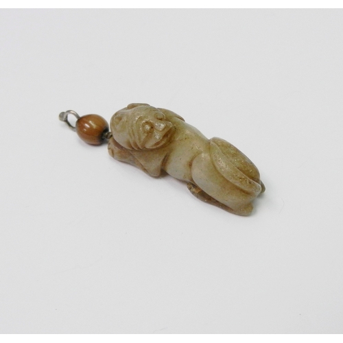 92 - An archaistic jade figure of a Qiling as a pendant, carved depicted looking backwards towards its ta... 